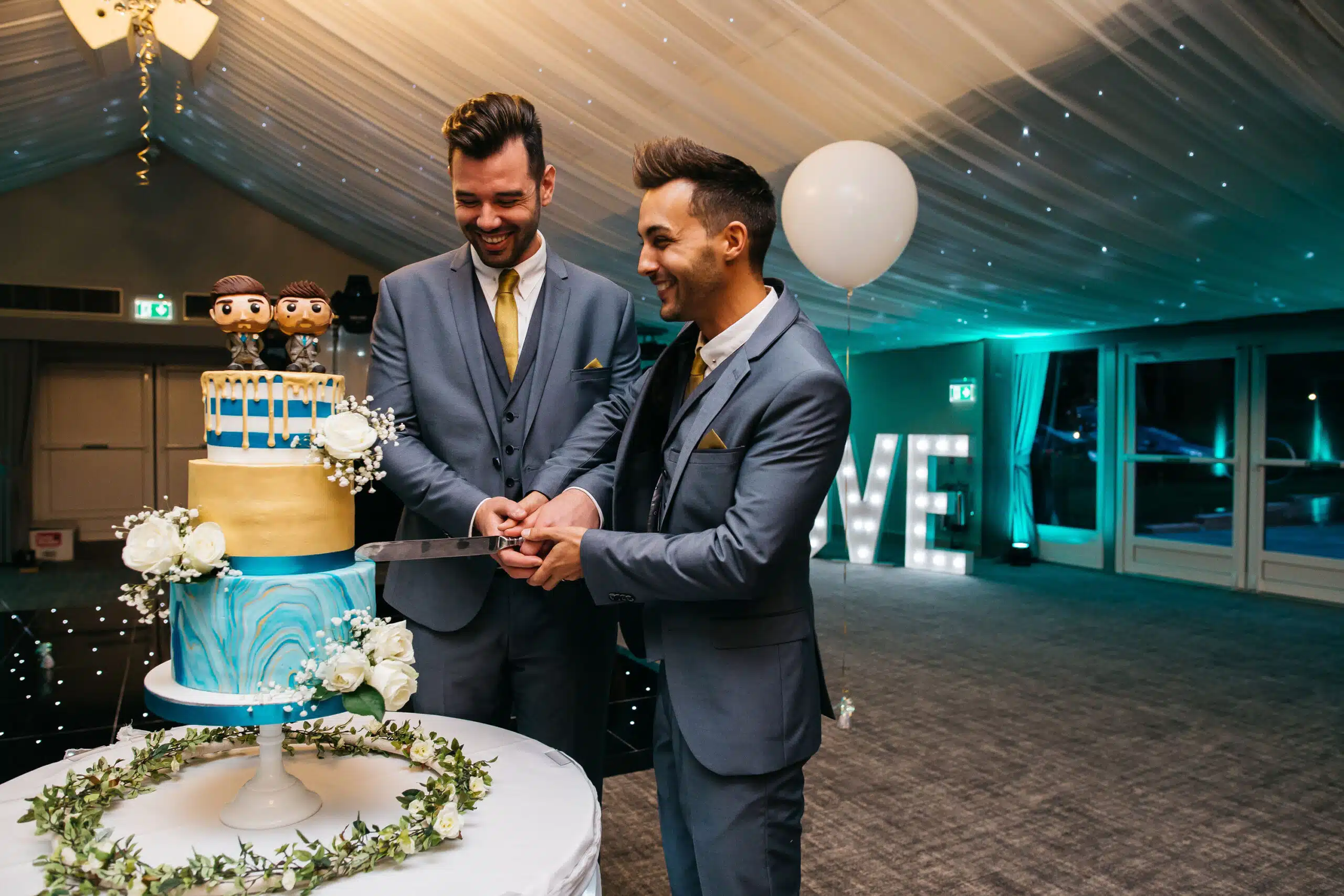 Groomsmen cutting the cake