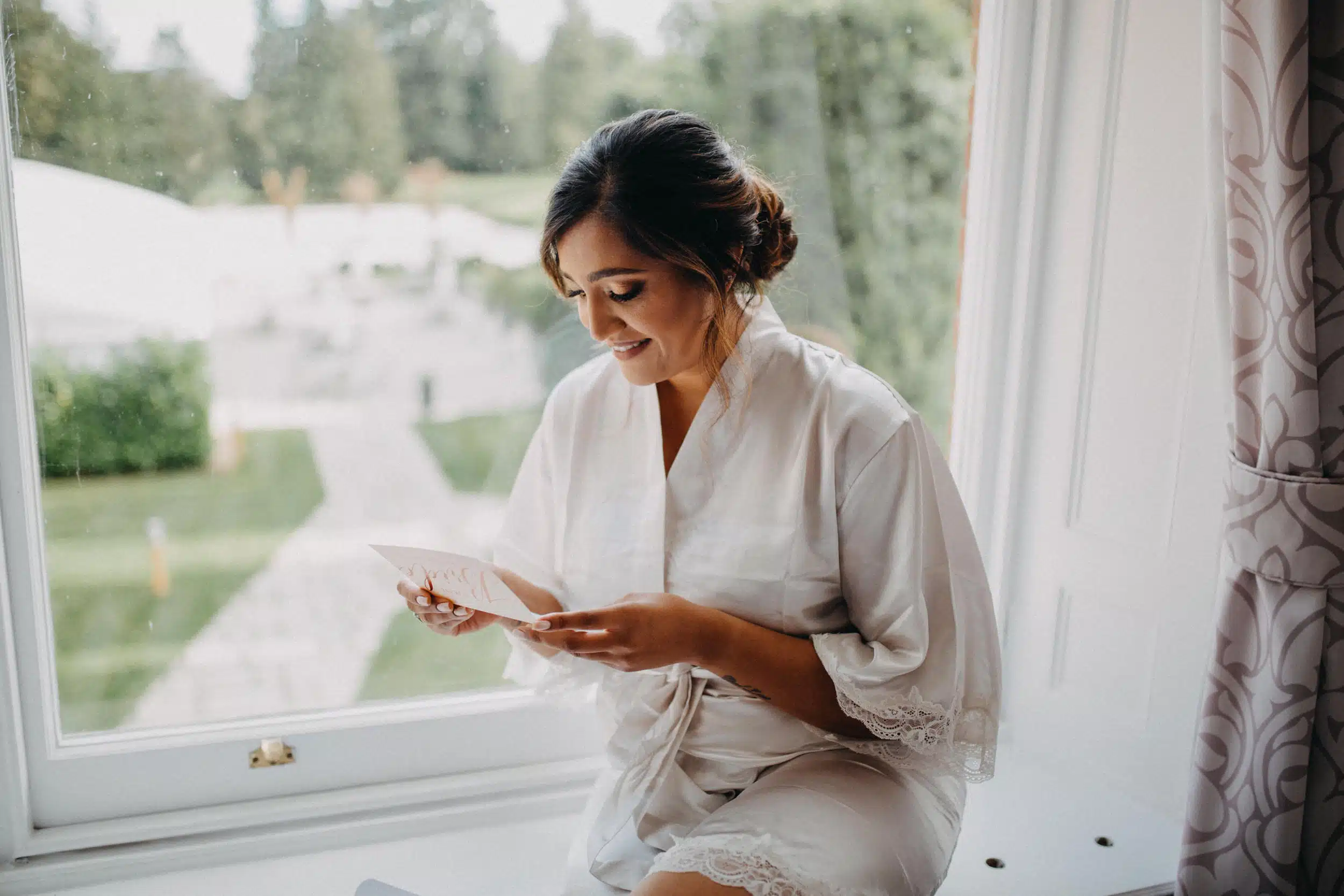 Bride sitting on window sill