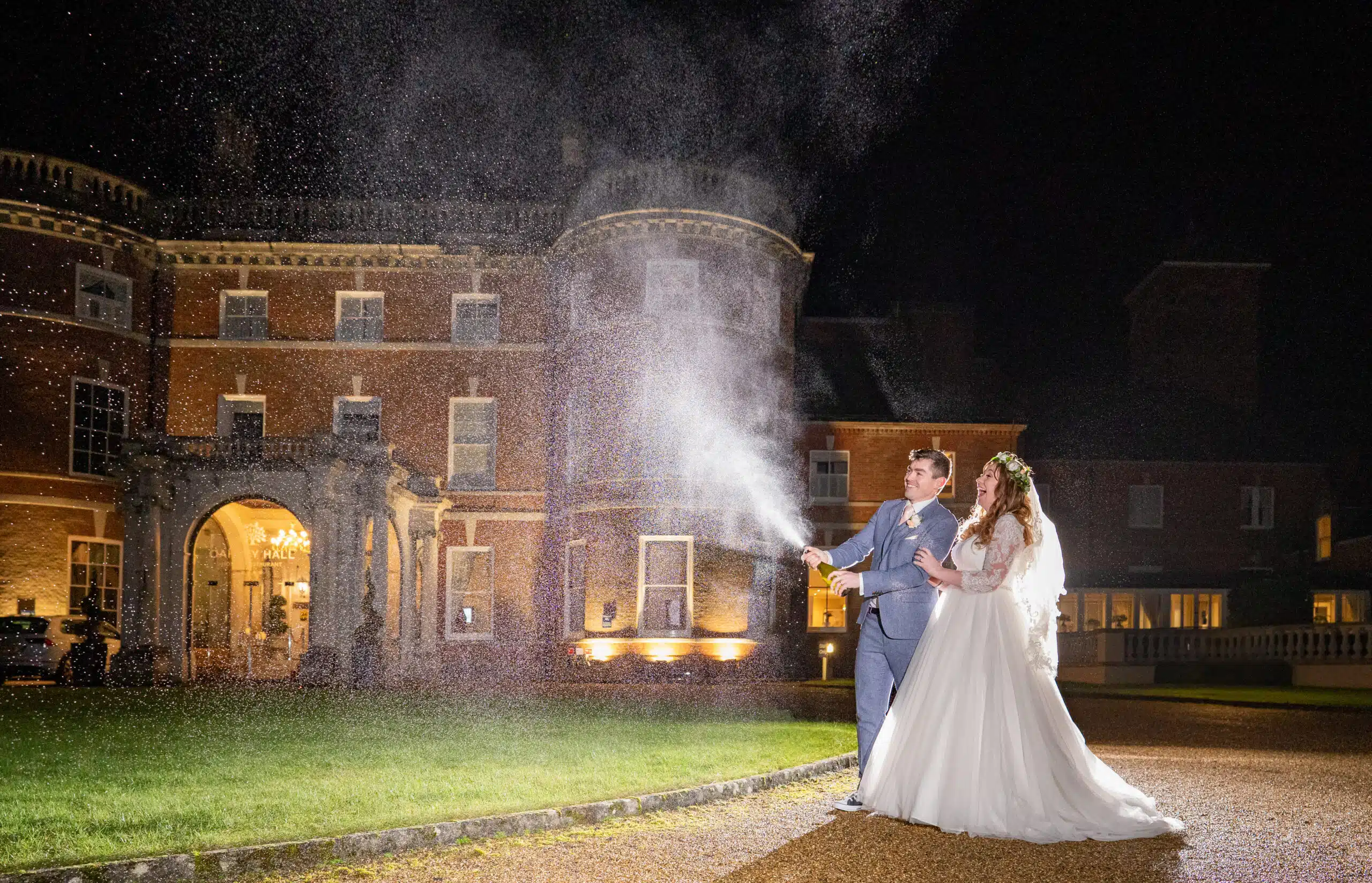 Champagne cork popping bride & groom